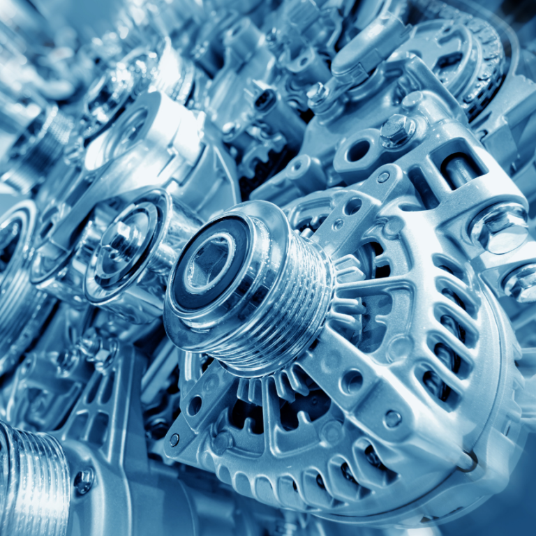 Glatte, metallische Maschinenkomponenten in bläulichem Licht angeordnet.